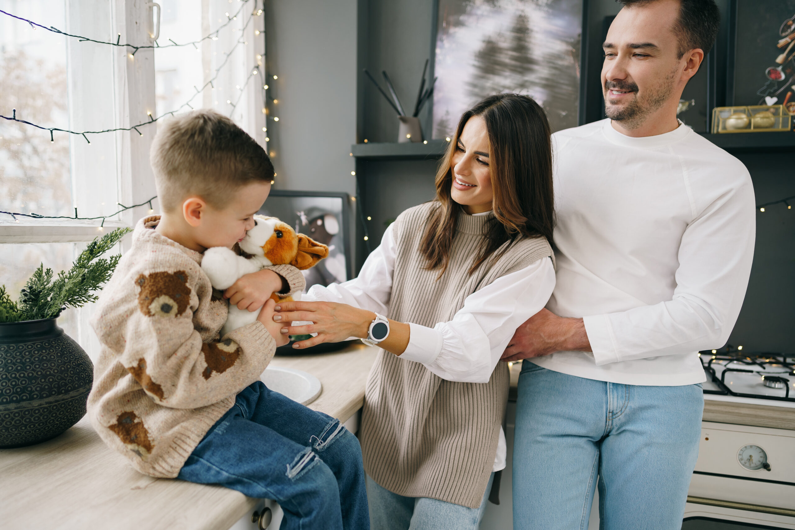 A portrait of happy family in the kitchen decorated for Christmas